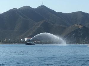 A tug spraying water in honor of the World ARC fleet leaving Santa Marta